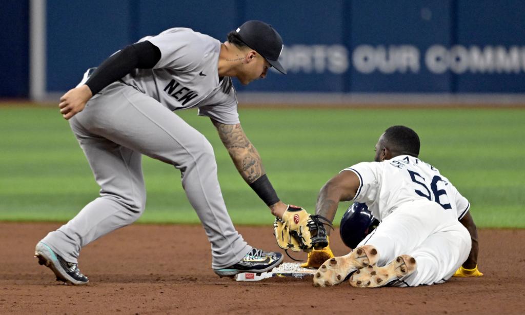 Tampa Bay Rays' Randy Arozarena (56) beats the tag from New York Yankees' Gleyber Torres to steal second base during the fifth inning of a baseball game Tuesday, July 9, 2024, in St. Petersburg, Fla. 