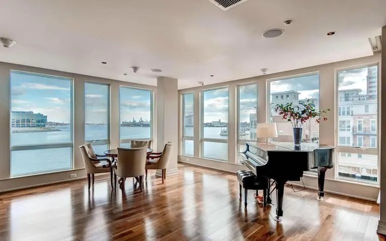 The breakfast space with floor to ceiling windows overlooking the water. 