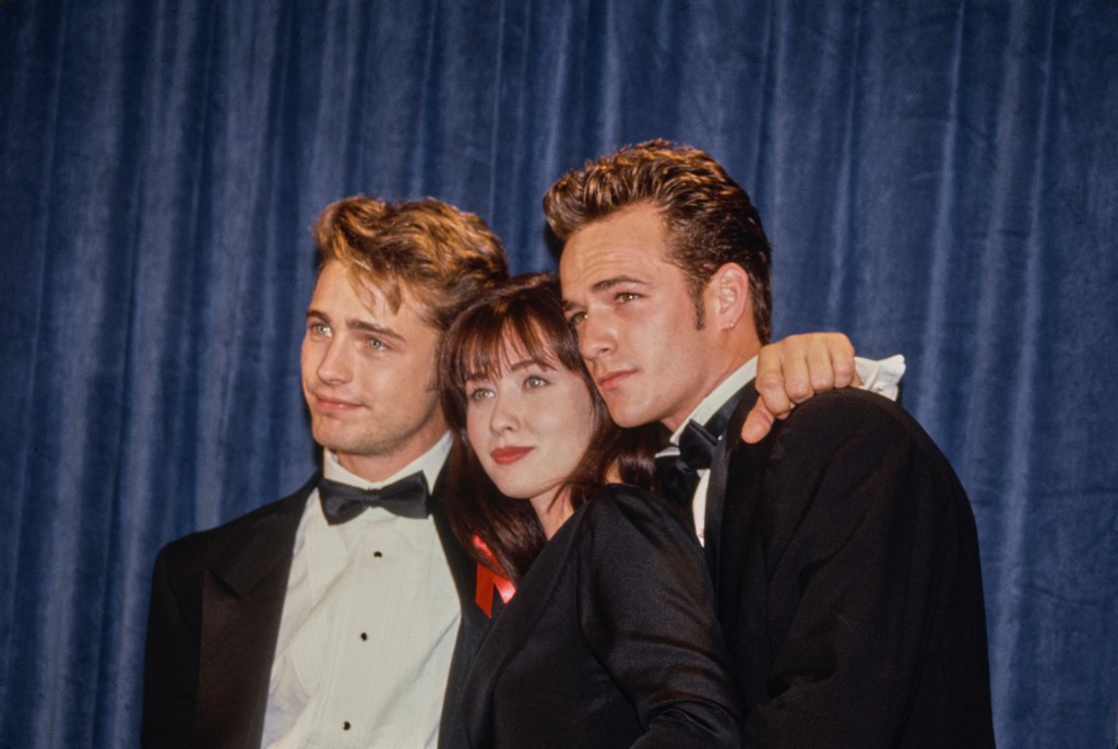 Shannen Doherty with her "Beverly Hills, 90210" co-stars, actors Jason Priestley and Luke Perry, at the Emmy Awards in 1991.