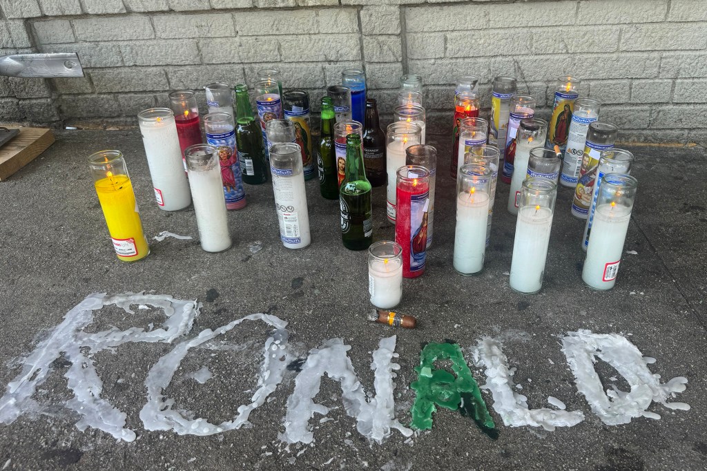 A makeshift shrine pays tribute to Gomez-Mesa outside the bodega.