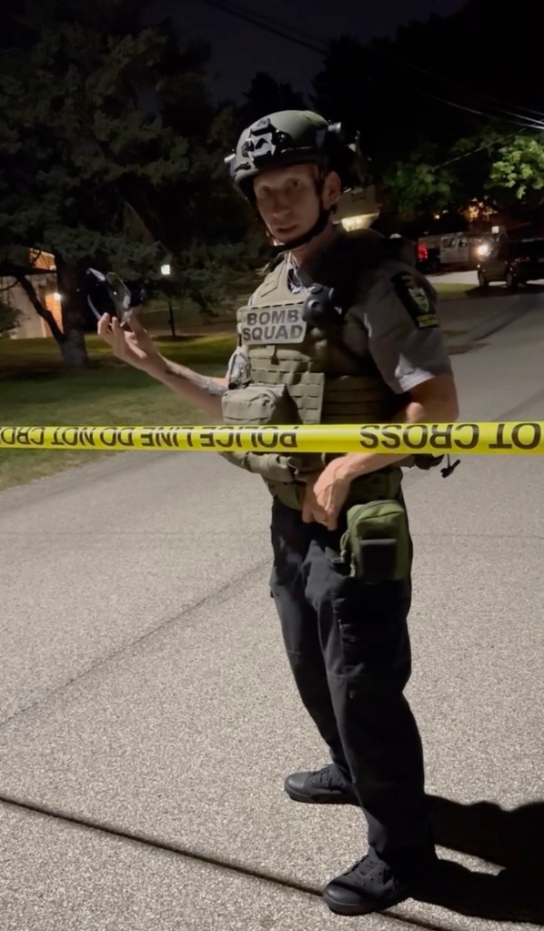 Bomb squad officer updates neighbors close to the home of Crooks.