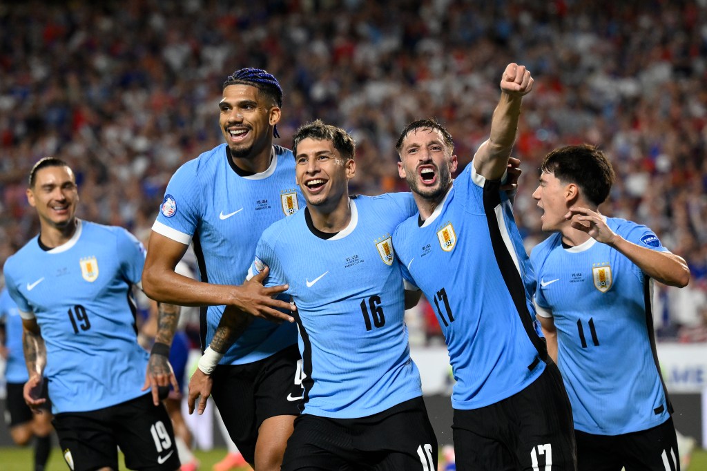Uruguay's Mathias Olivera (16), celebrates with teammates after scoring his side's opening goal against United States during a Copa America Group C soccer match on Monday.