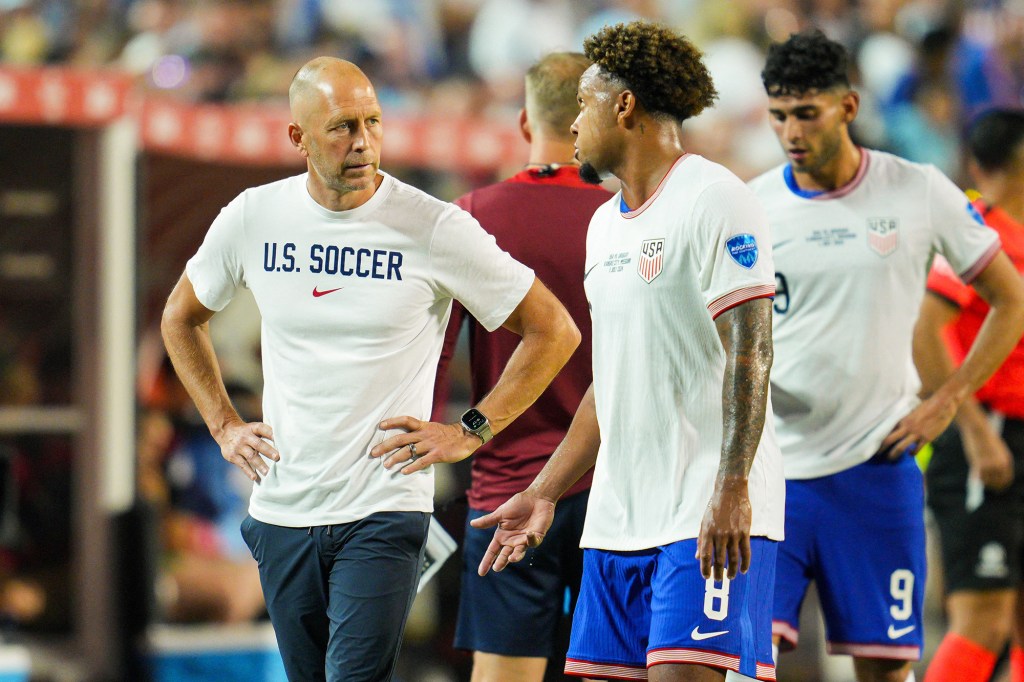 Gregg Berhalter and USMNT players react during a match against Uruguay.