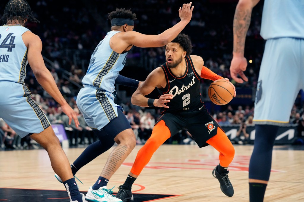 Detroit Pistons guard Cade Cunningham (2) is defended by Memphis Grizzlies guard Jordan Goodwin during the second half of an NBA basketball game, Monday, April 1, 2024, in Detroit.  