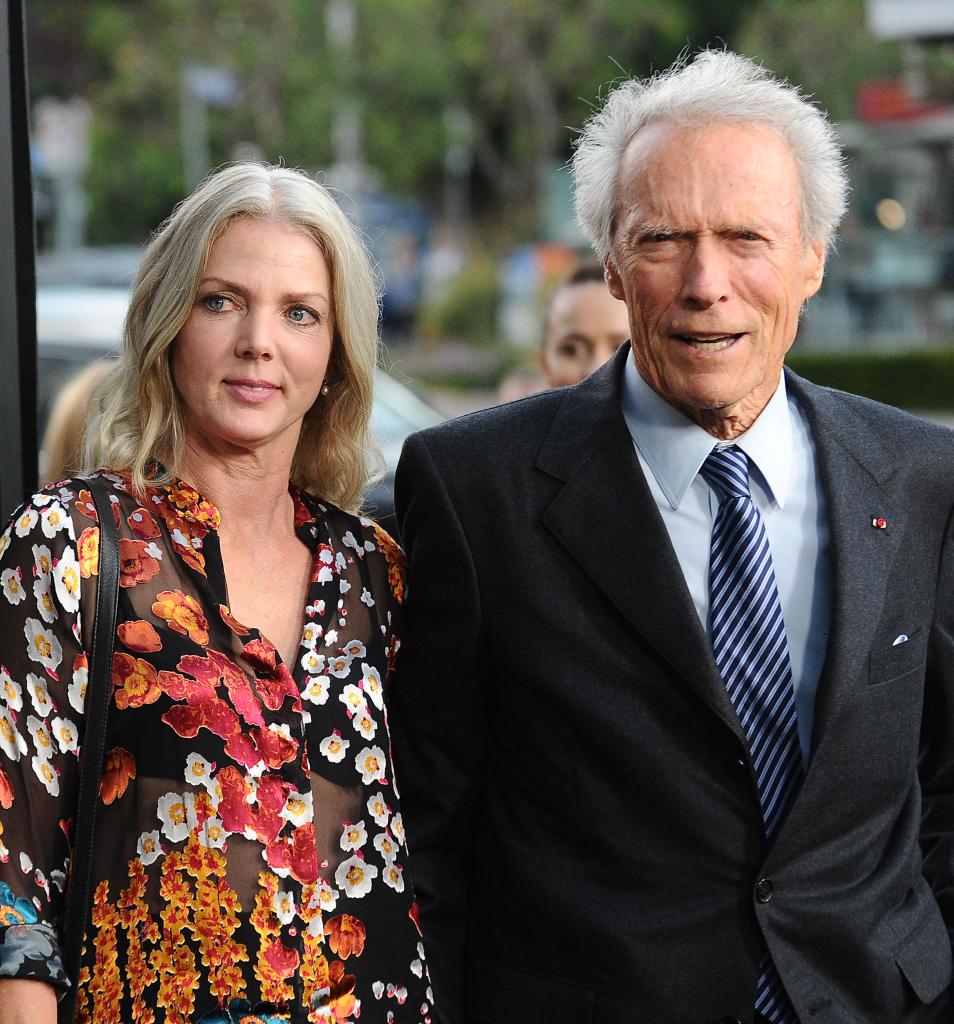 Clint Eastwood and Christina Sandera walking arm in arm at the screening of "Sully" in 2016.