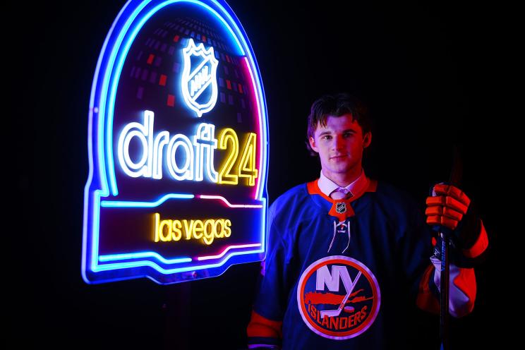 Cole Eiserman posing with his jersey after being selected 20th overall by the New York Islanders during the 2024 Upper Deck NHL Draft in Las Vegas, Nevada.