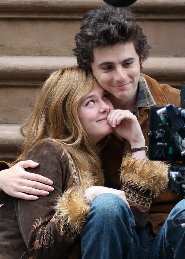 Elle Fanning and Timothee Chalamet smiling. 