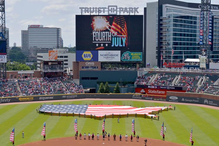 The Atlanta Braves honor America with a giant flag display and members of the Sons of the American Revolution in period dress at Truist Park on July 4, 2021 in Atlanta, Georgia.