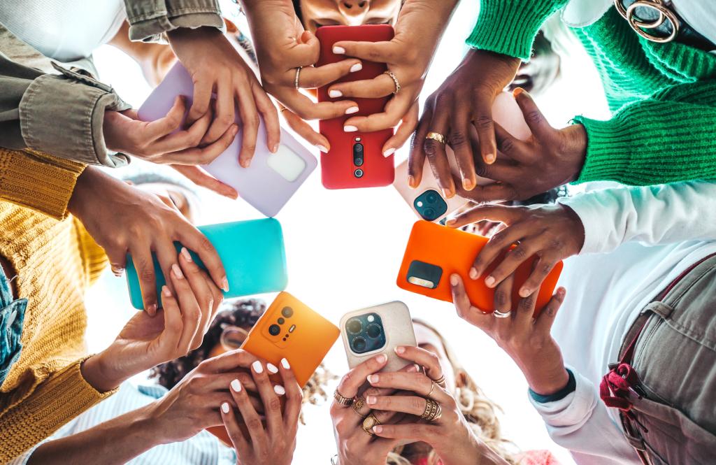 People holding cell phones. 