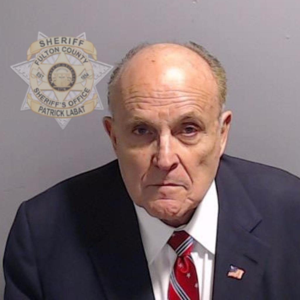 Rudy Giuliani, former personal lawyer for Donald Trump, posing for his booking photo at Fulton County Jail in Atlanta, Georgia.