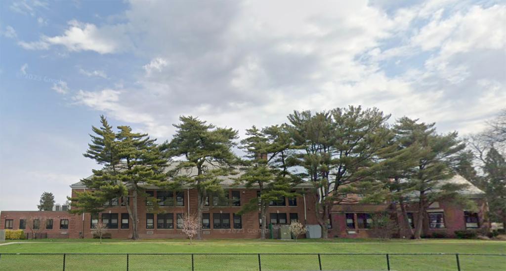 Hewitt Elementary School building with trees in front seen from google maps image