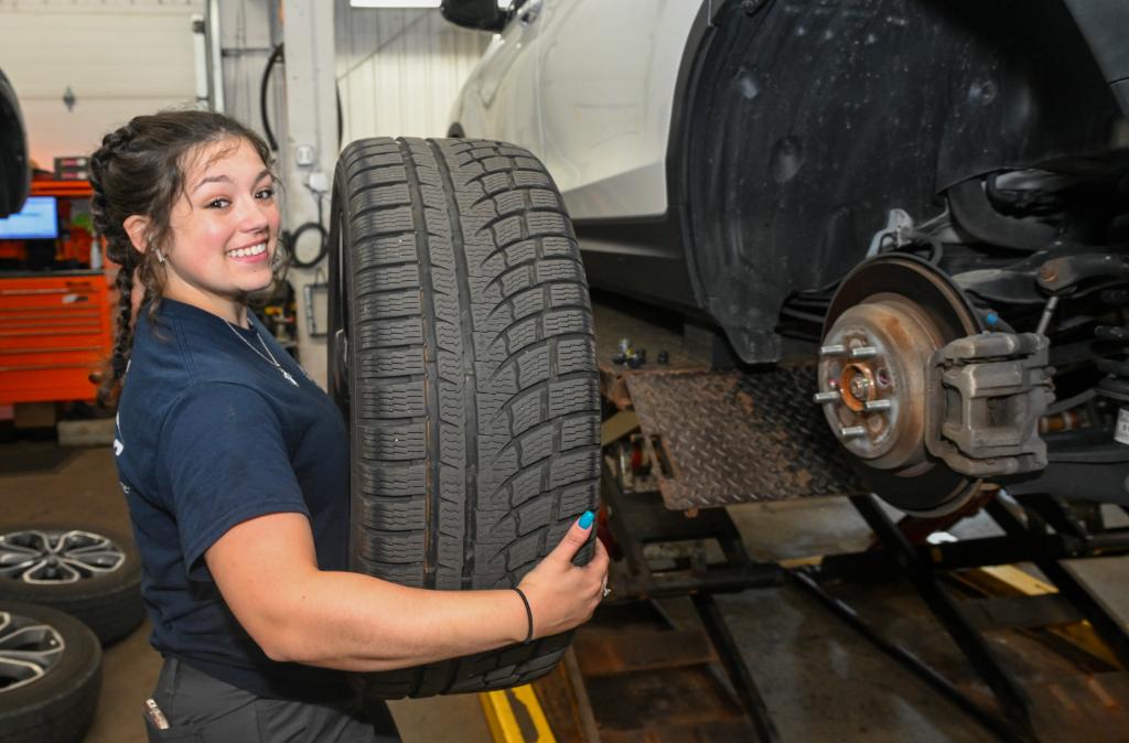 Emiley Filuta changing a tire