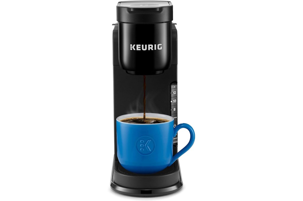 A coffee maker with a blue cup