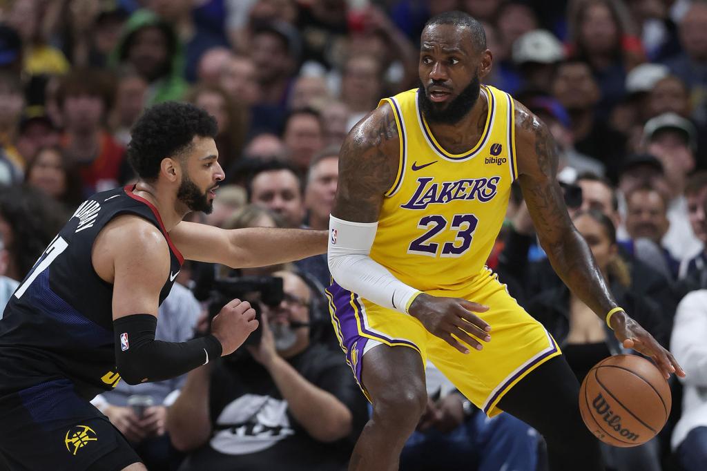 Jamal Murray #27 of the Denver Nuggets guards LeBron James #23 of the Los Angeles Lakers in the second quarter during game two of the Western Conference First Round Playoffs at Ball Arena on April 22, 2024 in Denver, Colorado. 