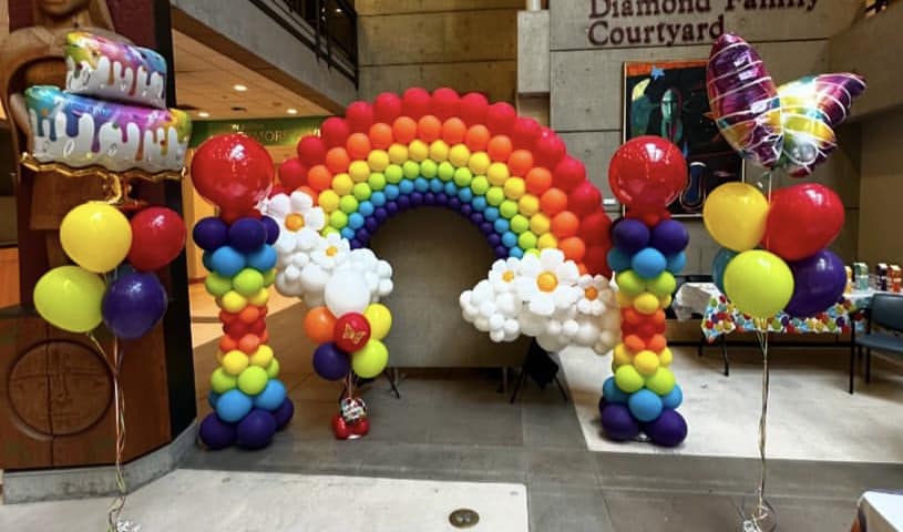 A rainbow baloon arch. 