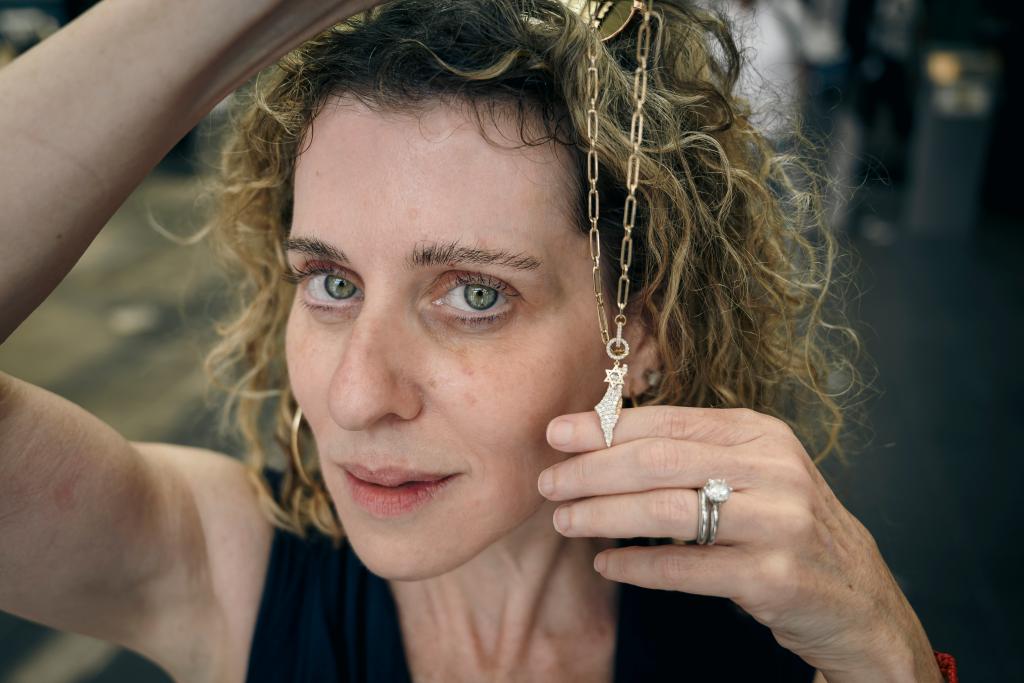 Melissa Chapman holding a Star of David necklace