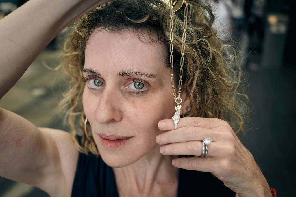Melissa Chapman holding a Star of David necklace