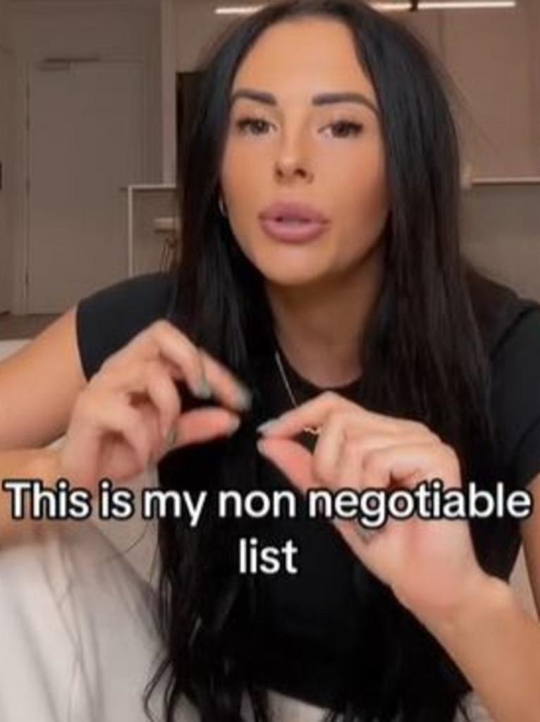 A woman with long black hair referring to her dating checklist