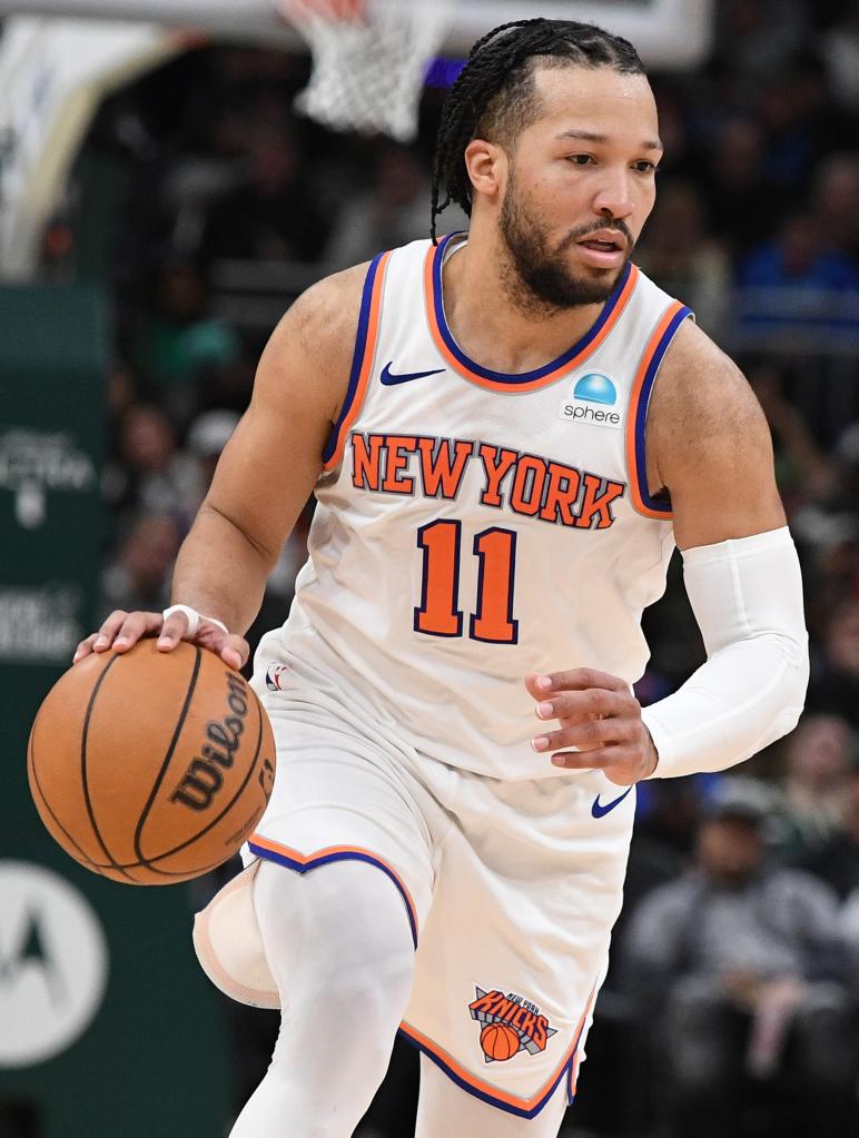 New York Knicks guard Jalen Brunson (11) brings the ball up the court against the Milwaukee Bucks in the second half at Fiserv Forum.