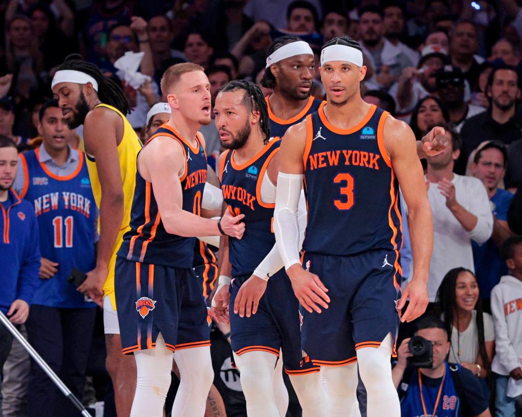 New York Knicks guard Jalen Brunson #11 is greeted by New York Knicks guard Donte DiVincenzo #0 along side New York Knicks guard Josh Hart #3 after hitting a shot and drawing a foul during the fourth quarter.