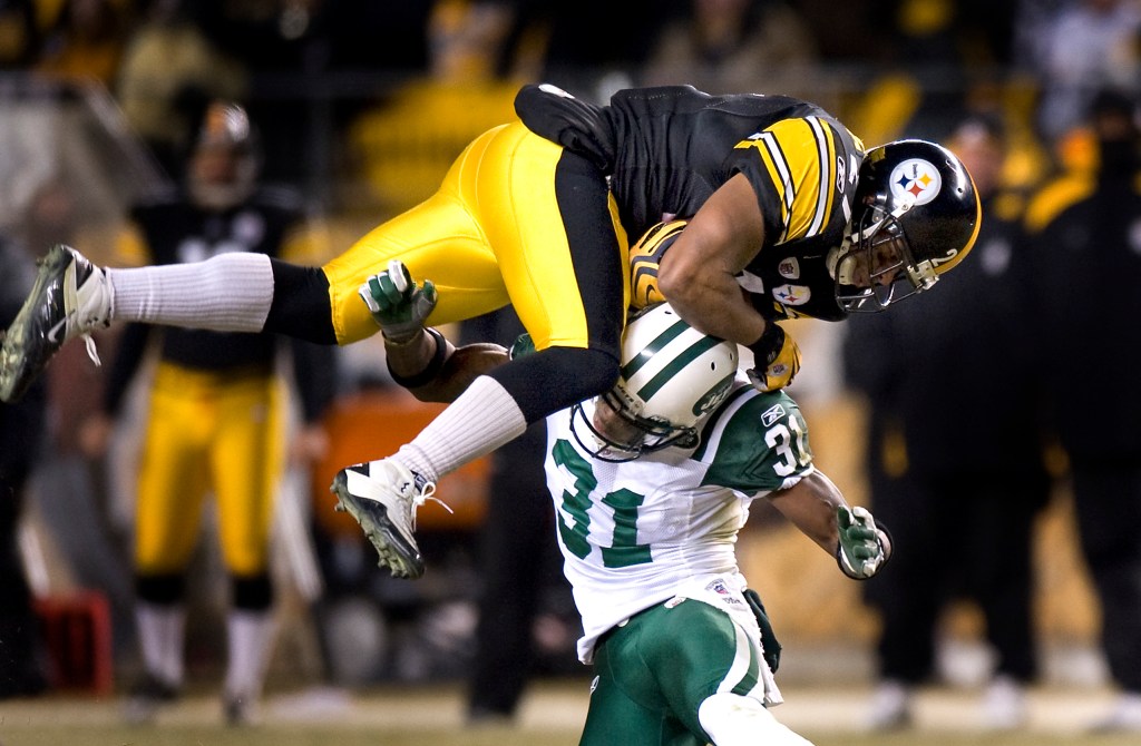 #21 Mewelrd Moore drives through Jets Antonio Cromartie during the second half.