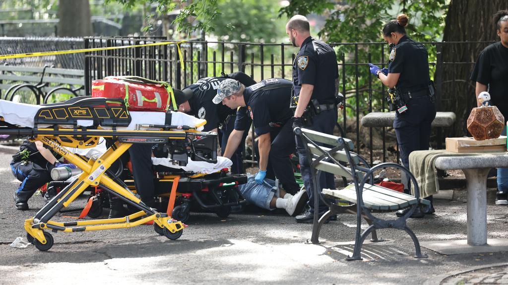 NYPD 9th pct officers and EMS transporting 1 of 2 shooting victims from Tompkins Square Park