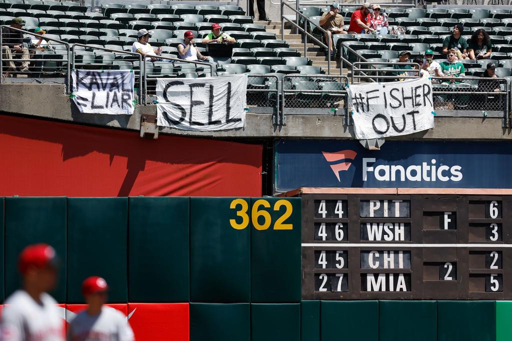 Oakland Athletics fans display signs during the game against the Cincinnati Reds at RingCentral Coliseum on April 29, 2023 in Oakland, California. The signs refer to the team's potential move to Las Vegas. 