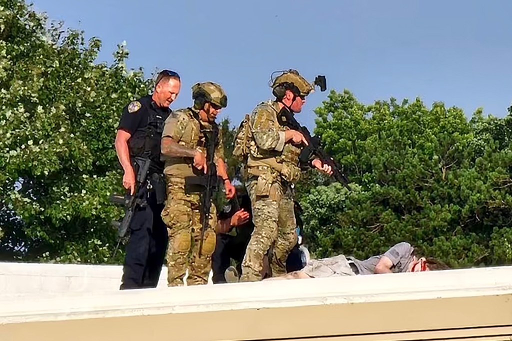 Officers stand over the body of shooter Thomas Matthew Crooks.