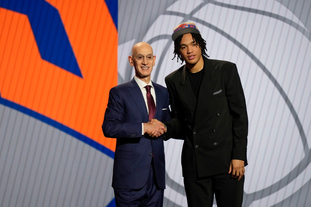 Pacome Dadiet, right, poses for a photo with NBA commissioner Adam Silver after being selected 25th by the New York Knicks during the first round of the NBA basketball draft, Wednesday, June 26, 2024, in New York.