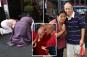 Dalai Lama's followers pray for his knee surgery recovery outside ritzy NYC hotel