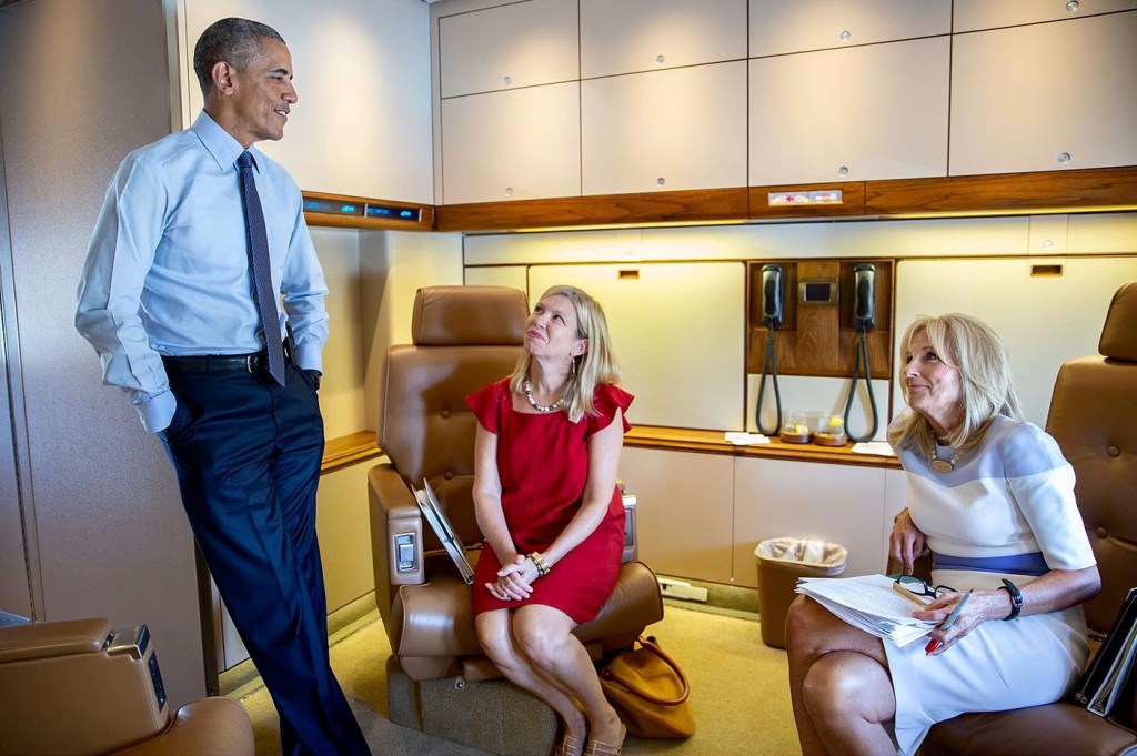 President Barack Obama in conversation with Dr. Jill Biden, who is grading papers, on board Air Force One, taken in 2015.