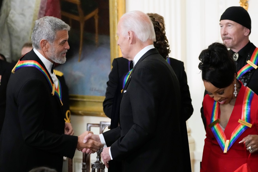 President Joe Biden shakes hands with George Clooney during the Kennedy Center honorees reception at the White House in Washington on Dec. 4, 2022.