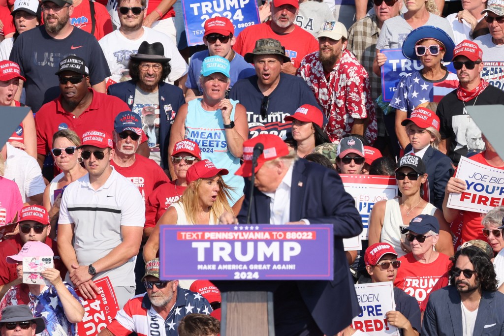 Republican presidential candidate and former U.S. President Donald Trump is assisted by security personnel after gunfire rang out during a campaign rally at the Butler Farm Show in Butler, Pennsylvania, U.S., July 13, 2024