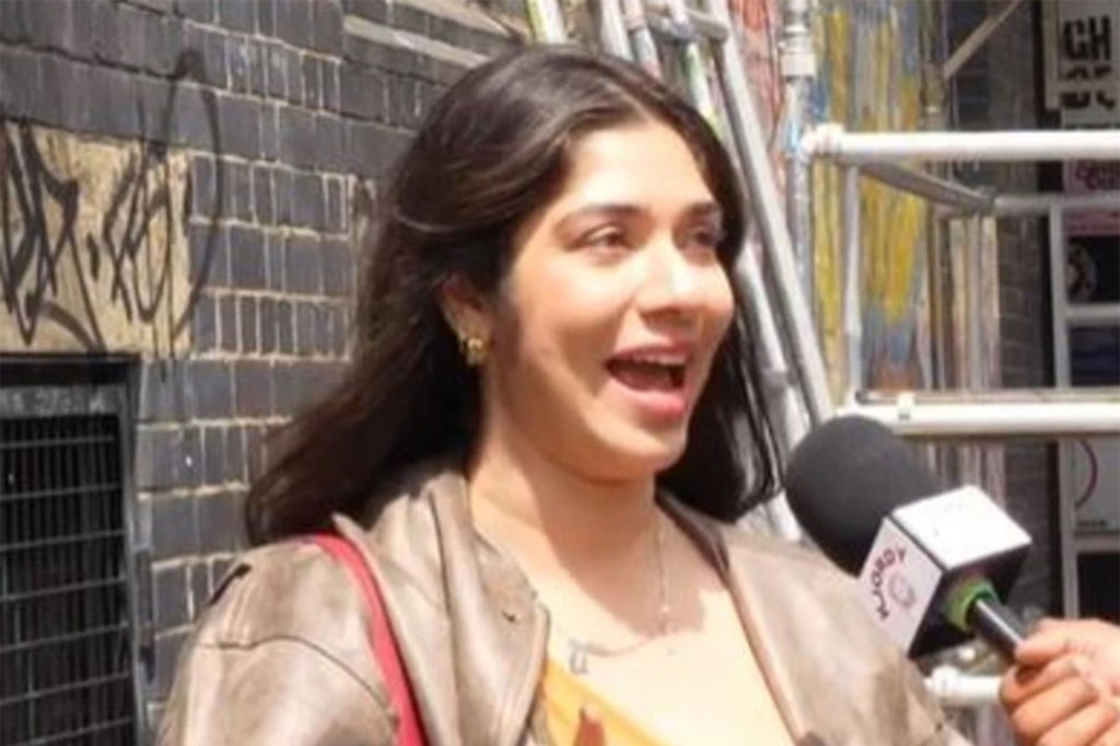 Australian woman speaking into a microphone on the street expressing her views about American patriotism