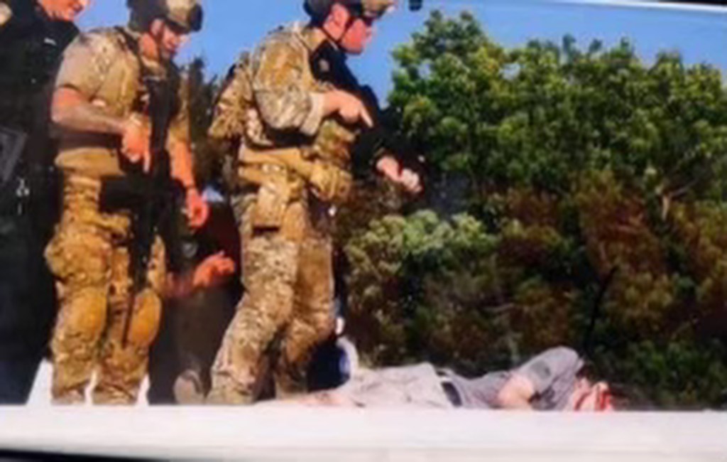 Officers stand over the alleged shooter in Butler, PA.