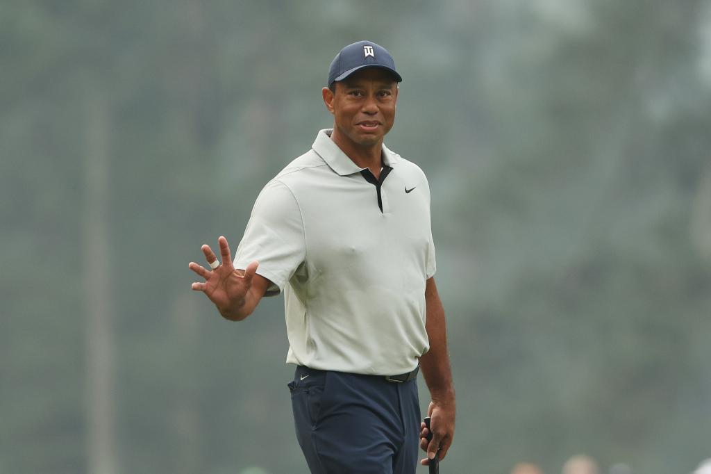 Tiger Woods of the United States waves on the third green during a practice round prior to the 2023 Masters Tournament at Augusta National Golf Club on April 04, 2023 in Augusta, Georgia.