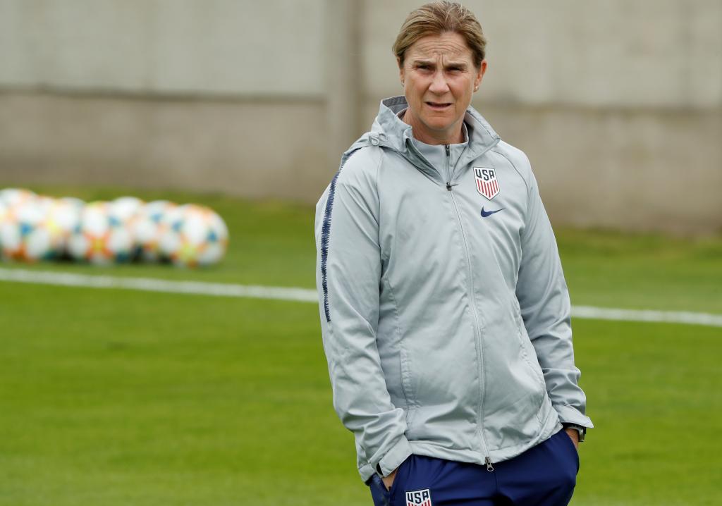 U.S. Women's World Cup coach, Jill Ellis, standing on a soccer field at a press conference and training session in Colombes, France
