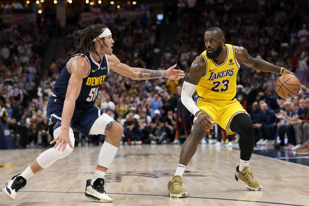 Aaron Gordon #50 of the Denver Nuggets guards LeBron James #23 of the Los Angeles Lakers in the third quarter during Game 5 of the Western Conference First Round Playoffs at Ball Arena on April 29, 2024 in Denver, Colorado.  