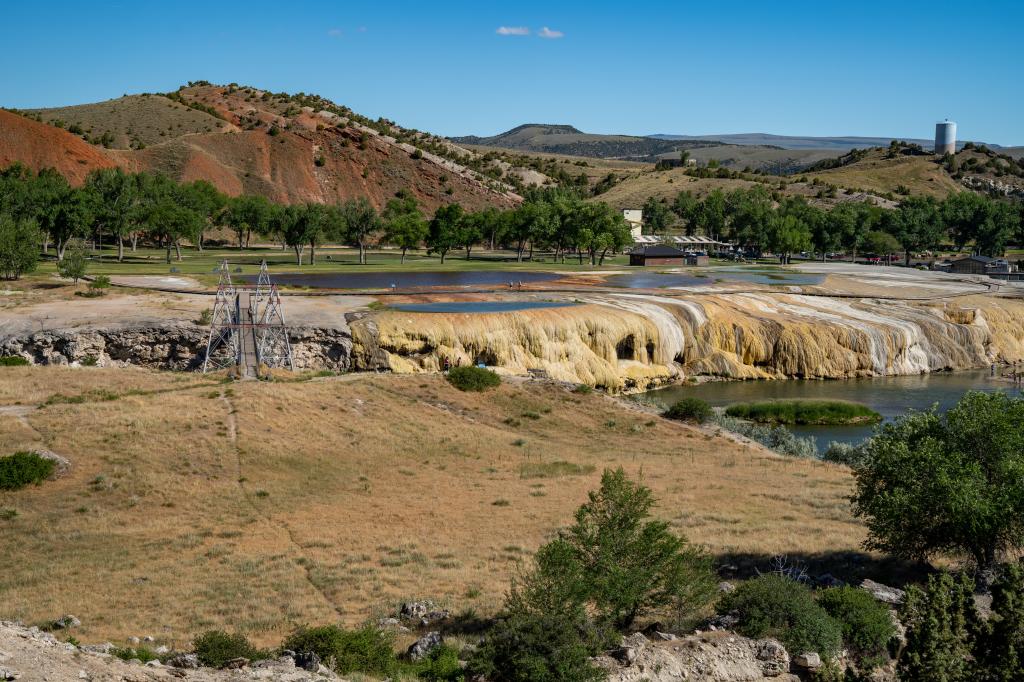 Landscape view of Hot Springs State Park in Thermopolis, Wyoming featuring a river and trees in a geothermal area