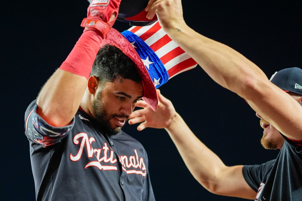 Washington Nationals' Luis Garcia Jr. gets a celebratory hat after his solo home run during the eighth inning on Wednesday,