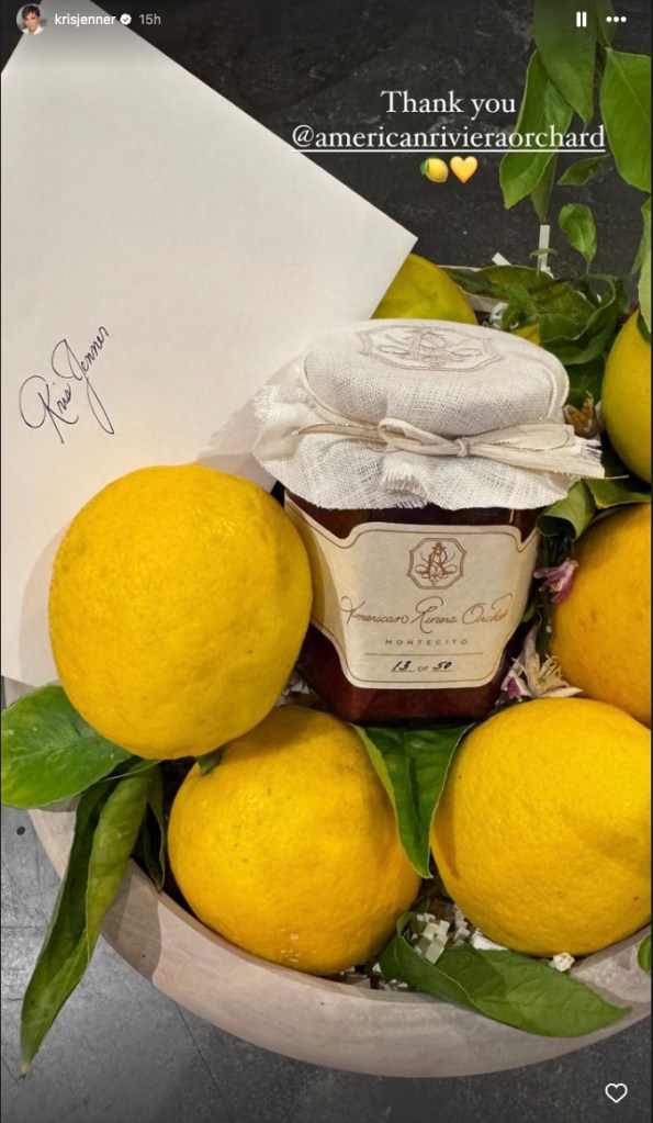 Kris Jenner holding a jar of strawberry jam gifted by Meghan Markle, placed on a pile of lemons