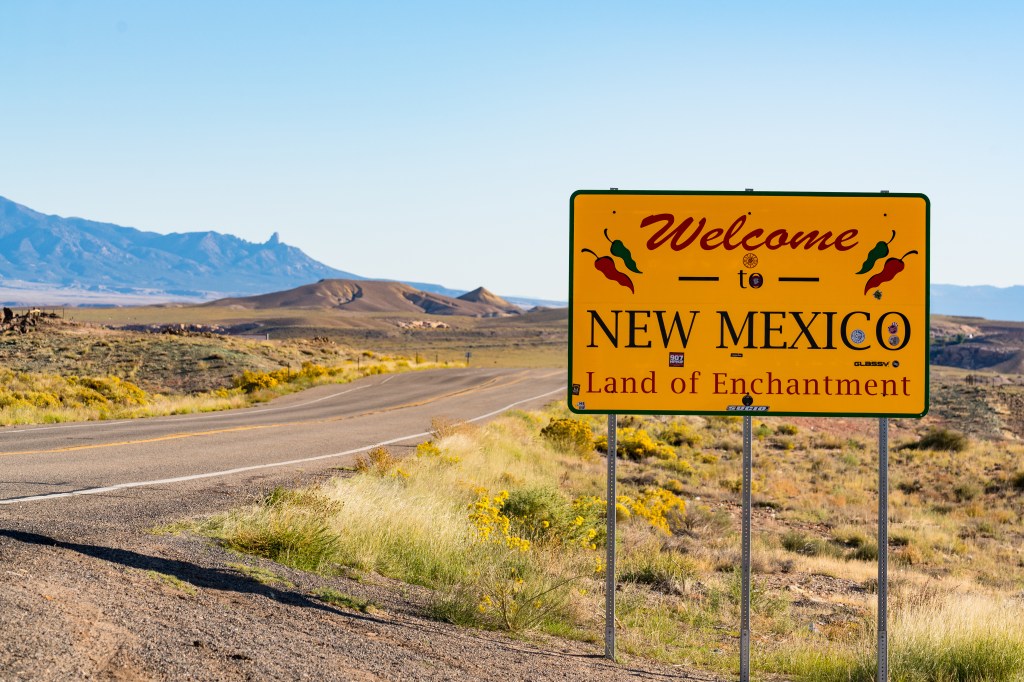 Welcome to New Mexico sign on the side of the road in Teec Nos Pos, Arizona