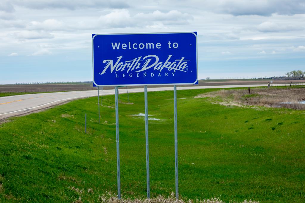 Welcome to North Dakota state road sign on a highway