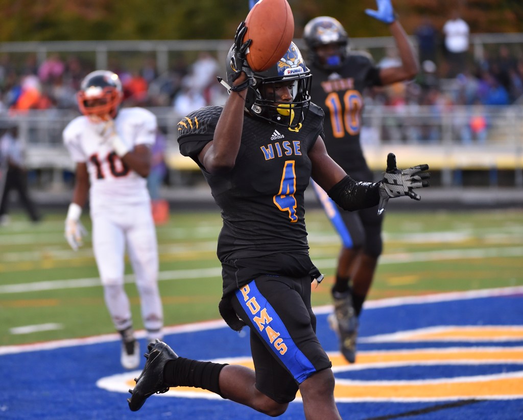 Wise's Anthony Lytton, Jr., holds up the ball after catching a touchdown pass during the third quarter at Wise High School on October 12, 2015.