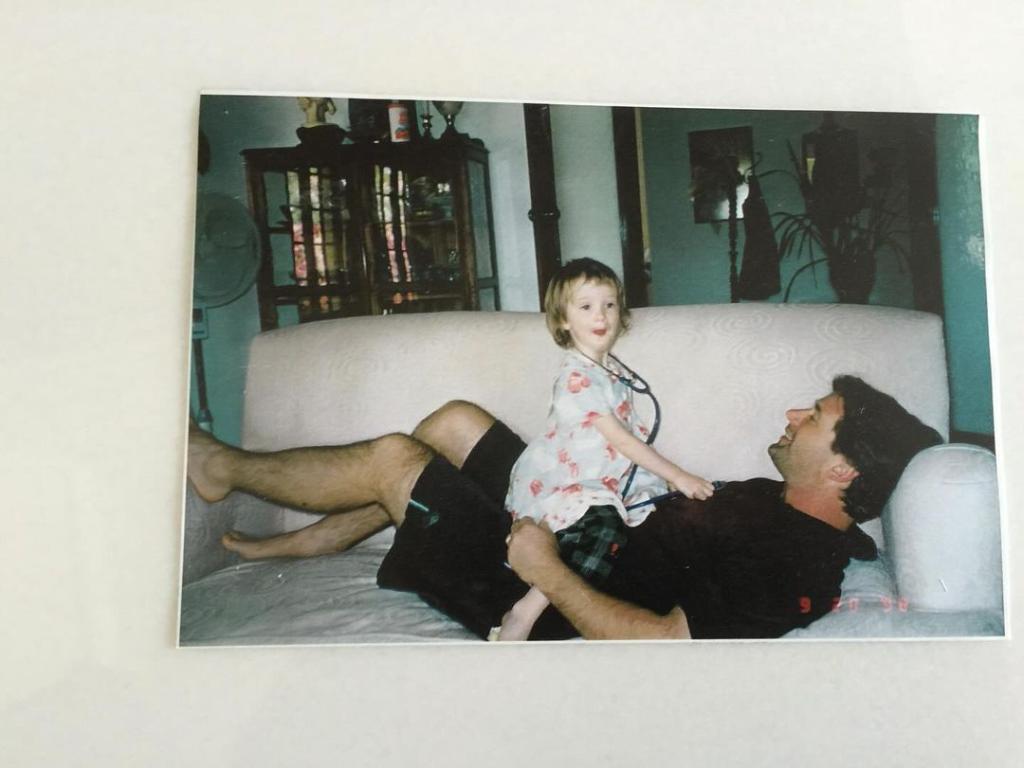 Ireland Baldwin as a toddler and Alec Baldwin sitting on a couch in a throwback photo