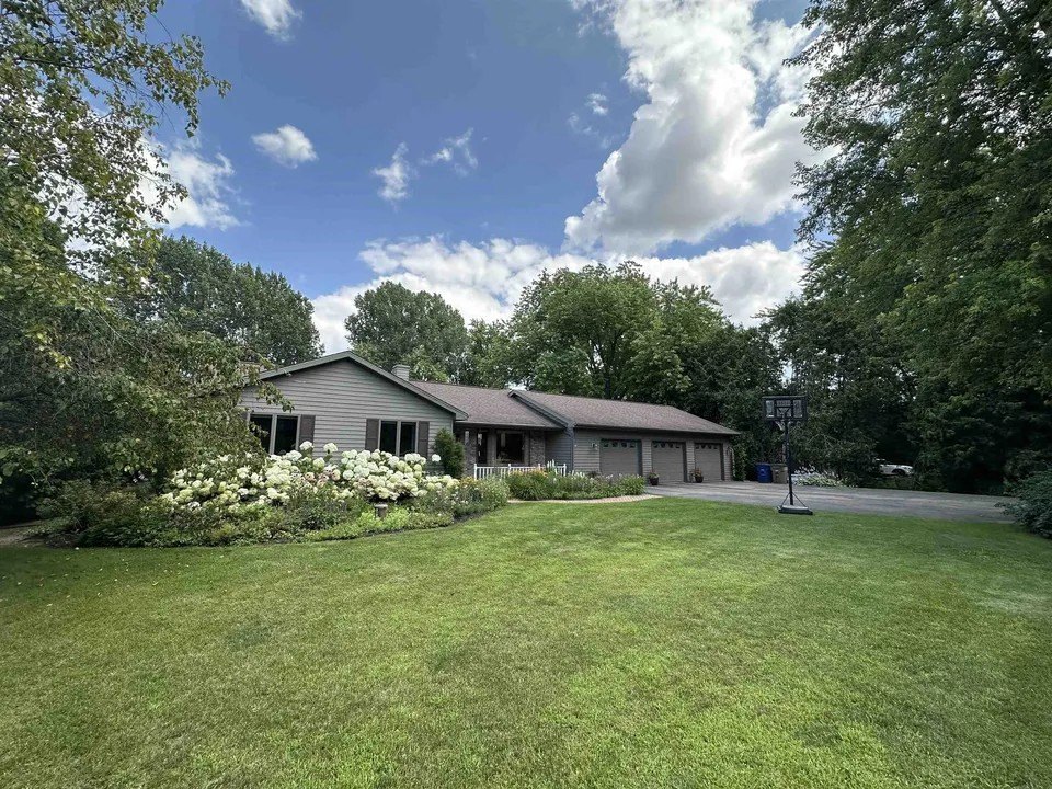 A house with a lawn and trees for sale in Oshkosh, Wisconsin, America's hottest housing market