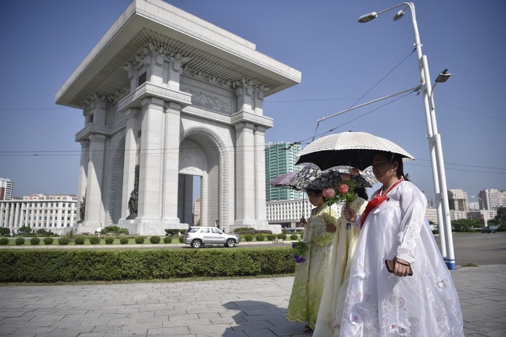 Pedestrians walk past the Arch of Triumph in Pyongyang on August 15, 2024, as North Korea marks its 79th National Liberation Day, commemorating the end of Japanese colonial rule at the end of World War II