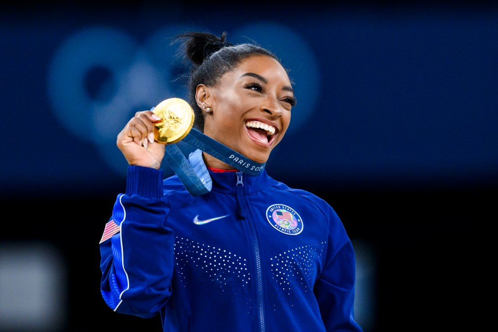 Gold medalist Simone Biles of Team United States celebrates on the podium during the medal ceremony for the Artistic Gymnastics Women's Vault Final on day eight of the Olympic Games Paris 2024 at the Bercy Arena on August 3, 2024 in Paris, France.