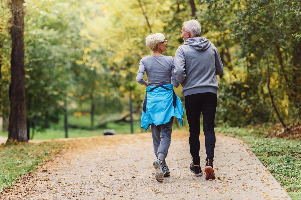 Senior couple jogging together in a park