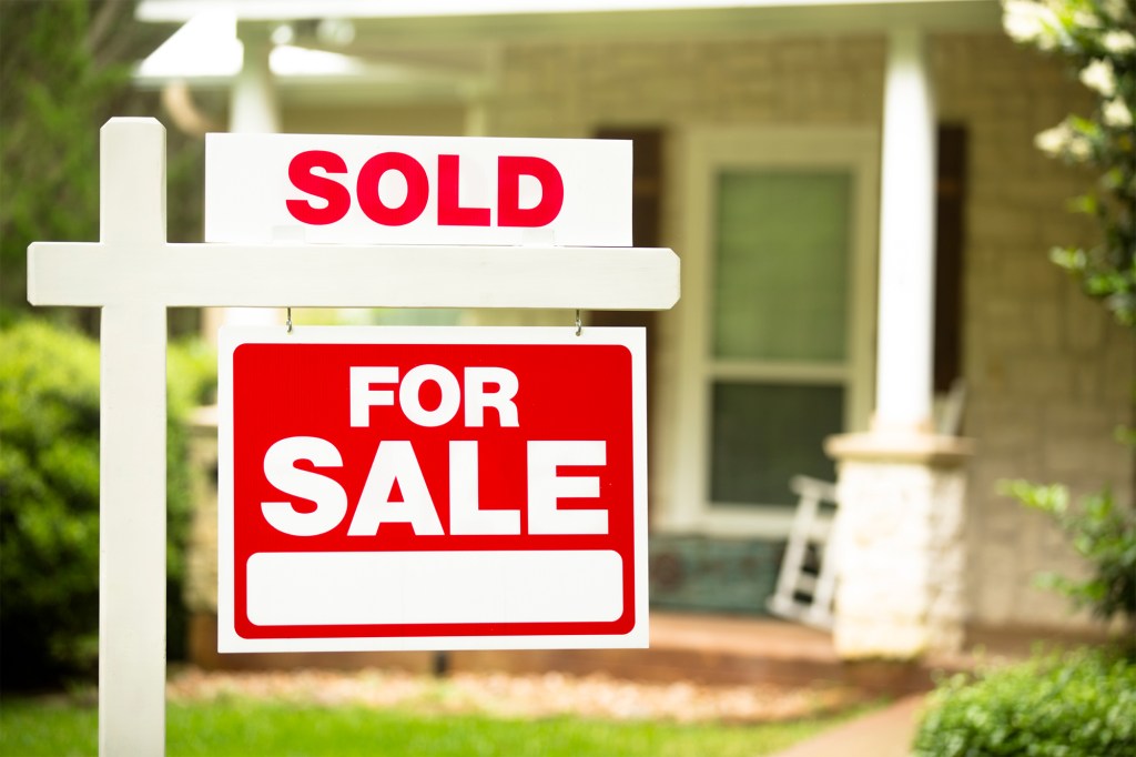 A for sale sign in front of a house